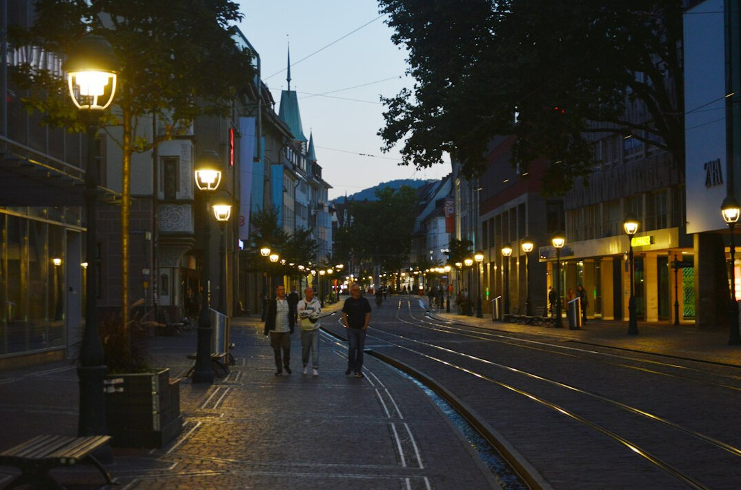 couple walking city street at dusk