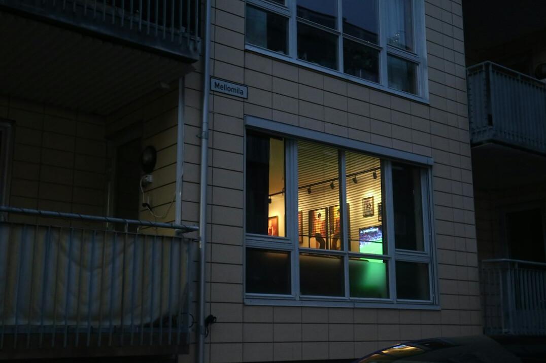 woman drawing on balcony at night