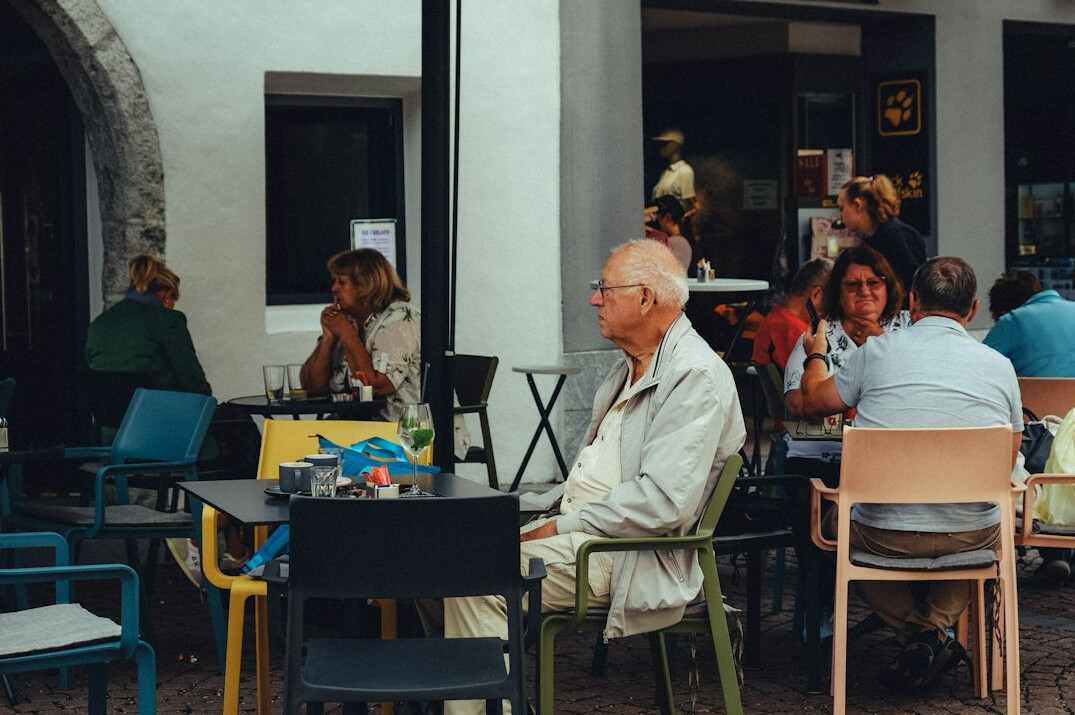 elderly woman talking in cafe