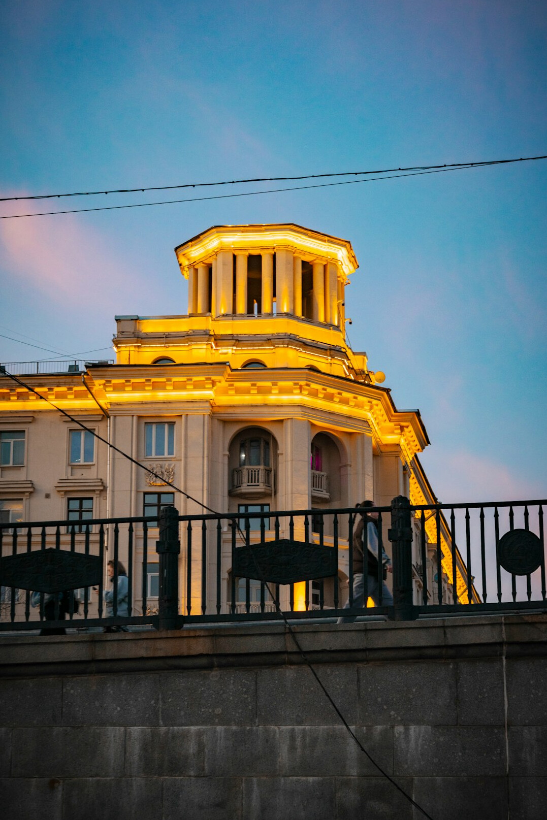 people on city balcony at sunset