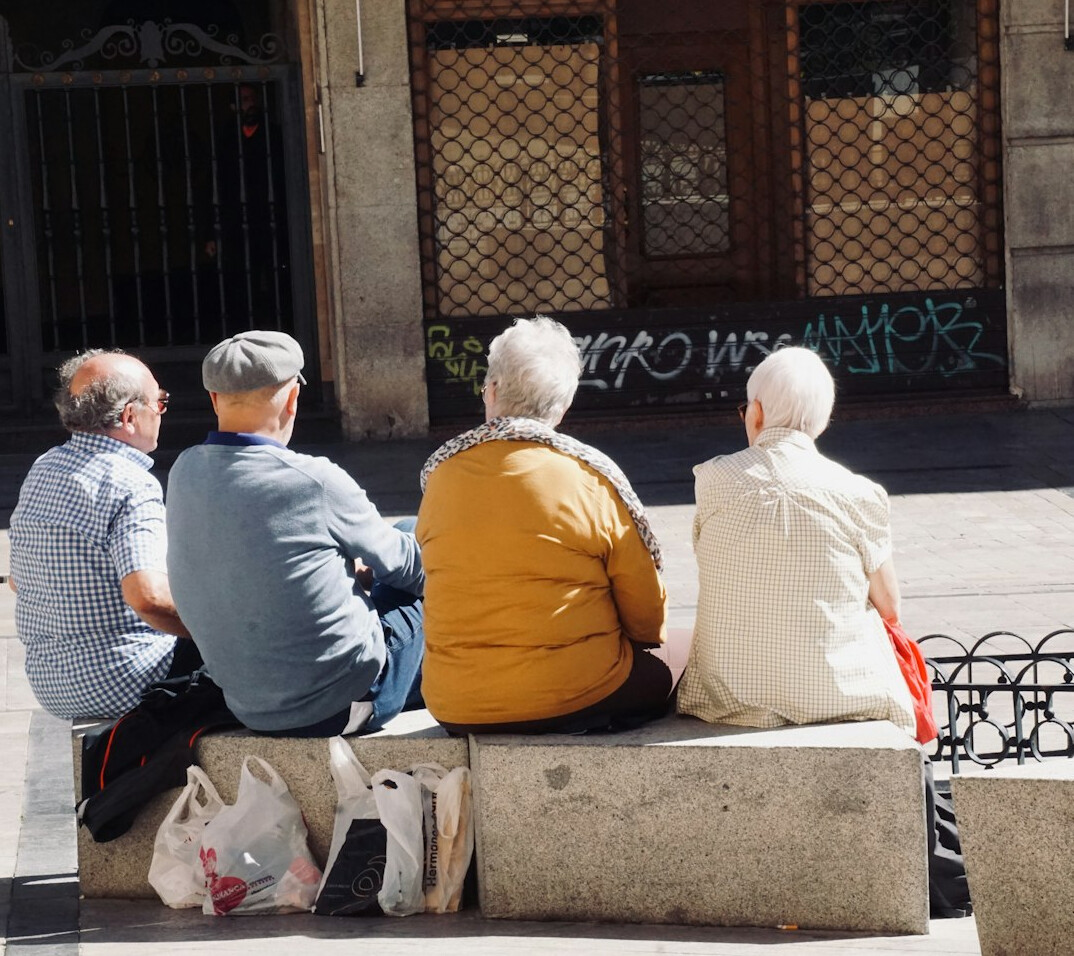 elderly woman chatting with neighbors